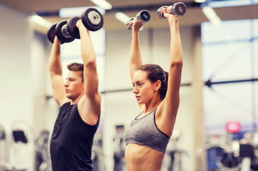 A young, fit couple exercising.